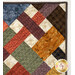 Close-up of a colorful patchwork quilt demonstrating fabric and top quilting details.