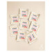 8 loose premium woven sew-in labels spread out on a cream background.