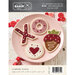 Front of the pattern featuring embroidered Valentine cookies shaped like an X, O, donut, heart, and strawberry on a pink plate.