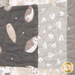 A close-up of a quilt featuring owl, leaves, and various neutral-colored fabrics..