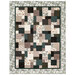 A patchwork quilt featuring a mix of squares in muted tones, with a floral border.