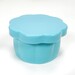 The blue Gypsy Quilter Magnetic Pin Cup closed with the lid on top, isolated on a white background.