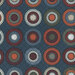 A patterned fabric featuring circular motifs in red, orange, beige, and brown on a dark blue background.