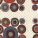 Colorful circular patterns in varying sizes, set against a cream fabric with a grid design.