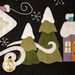 A close up on two applique trees, showing fabric, applique, and hand-embroidery details.