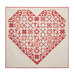 A large heart-shaped quilt in red and cream patterns isolated on a white background