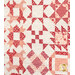 A patchwork quilt featuring various star patterns in shades of red and pink on a cream background.