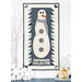 The completed Snowman Collector wall hanging, colored in icy off white and muted blue wool and cotton prints from the Snowman Gatherings IV collection by Moda Fabrics, hung on a white paneled wall and staged with coordinating snowflake and winter decor.