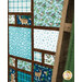 A stylized shot of the patchwork of the quilt, showing fabric details on various prints while a quilting ladder peeks into frame from the right side.