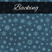 A swatch of dark teal blue fabric with tonal aqua snowflakes. A dark blue banner at the top reads 