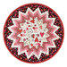 A round table topper with a bursting star design in red, pink, and white fabrics featuring valentine motifs isolated on a white background.