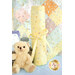 A light yellow rolled changing mat with colorful dots next to a teddy bear and a baby bottle.