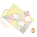 A multicolored changing mat featuring pastel patches with polka dots and playful patterns.