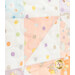 Close-up of a pastel quilt featuring colorful polka dots, floral patterns, and playful shapes.