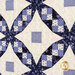 Blue and cream quilt featuring diamond shapes and floral patterns in a patchwork design.