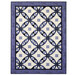 A quilt displaying a geometric pattern of navy blue and cream diamonds isolated on a white background