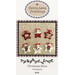 The front of the Christmas Stars pattern featuring the finished ornaments displayed on a wool background.