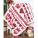 A quilt featuring vibrant red hearts and floral patterns draped over a white table.