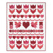 A white patchwork quilt featuring red and pink hearts, flowers, and birds arranged in a pattern isolated on a white background