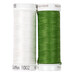 Two spools of thread in green and white, isolated on a white background.