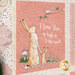 Up close of cream and pink children's quilt featuring bunnies, birds and sweet sayings