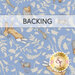 A swatch of sky blue fabric with sprawling leaves amongst hares, hedgehogs, and birds. A banner at the top reads 
