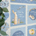 A cream and blue children's quilt featuring bunnies, birds and sweet sayings