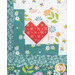 Close-up of quilt block with a heart shape in the center, surrounded by patterned borders in teal and white.