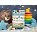A stack of colorful children's fabric fat quarters staged with a teddy bear, a stacking toy, and decorative star and moon figures.