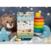 A stack of the fabrics in the Baby Boy collection, with ribbon and a star and a moon and a lion plush and a stacking ring toy and thread. 