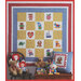 A colorful quilt with various playful squares hangs on a wall, surrounded by stuffed toys and a decorative pillow.