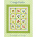 A quilt design titled Cottage Garden featuring colorful floral blocks on a polka dot background.