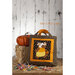 The completed Candy Corn Moose tote bag displayed on a wooden table next to a small bale of hay with a pumpkin resting on top.