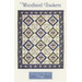 Cover of the Woodland Baskets quilt pattern featuring intricate basket designs in a diamond layout.