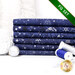 A stack of the six fabrics included in the 6 FQ Set Dark Blue/Silver by Stof Fabrics, with ornaments and thread.