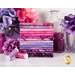 A stack of the batik fabrics included in the Bali Batiks - Amethyst FQ set, with flowers and jars and a bottle and thread.