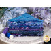 A stack of the batik fabrics included in the Bali Batiks Wisteria Blooms FQ set, with a cake stand and flowers and thread.