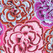 Colorful floral pattern featuring various carnations in shades of pink, purple, and orange on a pink fabric