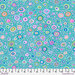 Colorful polka dots of varying sizes in shades of pink, green, and blue against a turquoise fabric