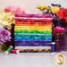 A stack of the fabrics included in the Fresh Blends collection, with flowers and jars and thread.