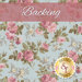 A swatch of light blue fabric with pink roses. A pink banner reads 