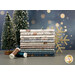 A stack of the fabrics included in the Cozy Cubs collection, with a gold snowflake and pine trees and thread.