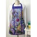 Apron with a floral design featuring various colorful flowers against a light background, displayed on a mannequin.