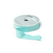 A spool of light aqua ribbon with a portion unspoiled isolated on a white background.