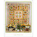 A quilt titled August Blooms featuring floral designs and star patterns, displayed with vibrant flowers.