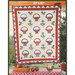 A quilt featuring a pattern of baskets and blue flowers on a white background, surrounded by a red and blue border.