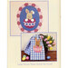 Image featuring a whimsical Easter bunny design on a mat, accompanied by a tea towel with a similar motif and colorful eggs.