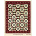 A patterned quilt featuring wreath designs with red, green, and white, bordered in dark red.