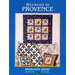 Cover of Weekend in Provence featuring a quilt and decorative pillows with floral patterns.