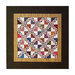 Colorful quilt featuring a geometric pattern of triangles in a square frame against a dark background.